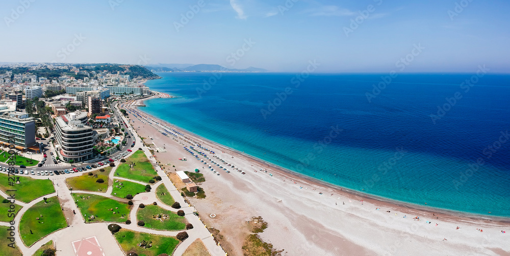 Aerial birds eye view drone photo of Elli beach on Rhodes city island, Dodecanese, Greece. Panorama with nice sand, lagoon and clear blue water. Famous tourist destination in South Europe