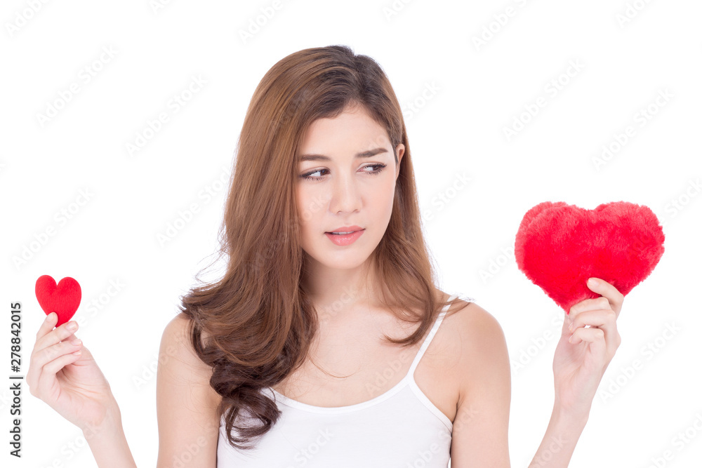 Portrait of beautiful asian young woman smiling holding red heart shape pillow choice big and small isolated on white background, valentines day, holiday concept. Portrait of beautiful asian young woman smiling holding red heart shape pillow choice big and small isolated on white background, valentines day, holiday concept.