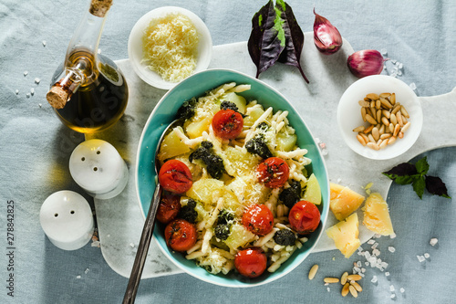 Quadro em tela Italian pasta trofie with potato, fried cherry tomatoes and basil pesto