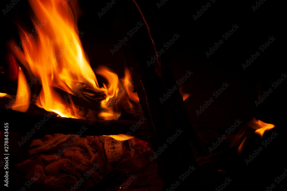 Trunks of dry trees fanning the flames of a stove photo taken with the help of a tripod at low speed with natural light.. Trunks of dry trees fanning the flames of a stove photo taken with the help of a tripod at low speed with natural light..