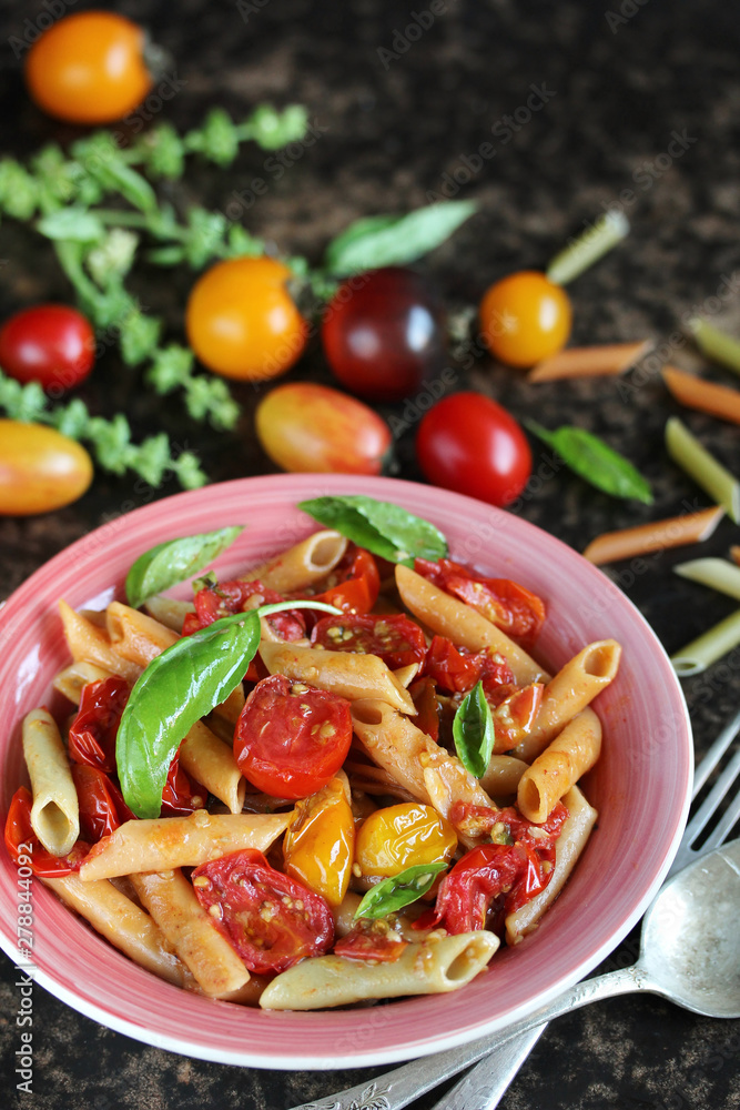 Penne pasta with cherry tomatoes confit. multicolored cherry Penne pasta with cherry tomatoes confit. multicolored cherry