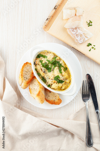 Cod casserole with mussels, creamy gravy, parmesan cheese and provencal herbs, served with french baguette and garlic oil