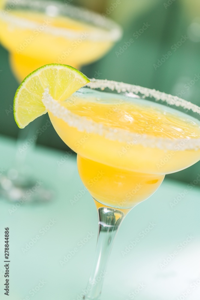 Yellow Cocktail with Lime Garnish Yellow Cocktail with Lime Garnish
