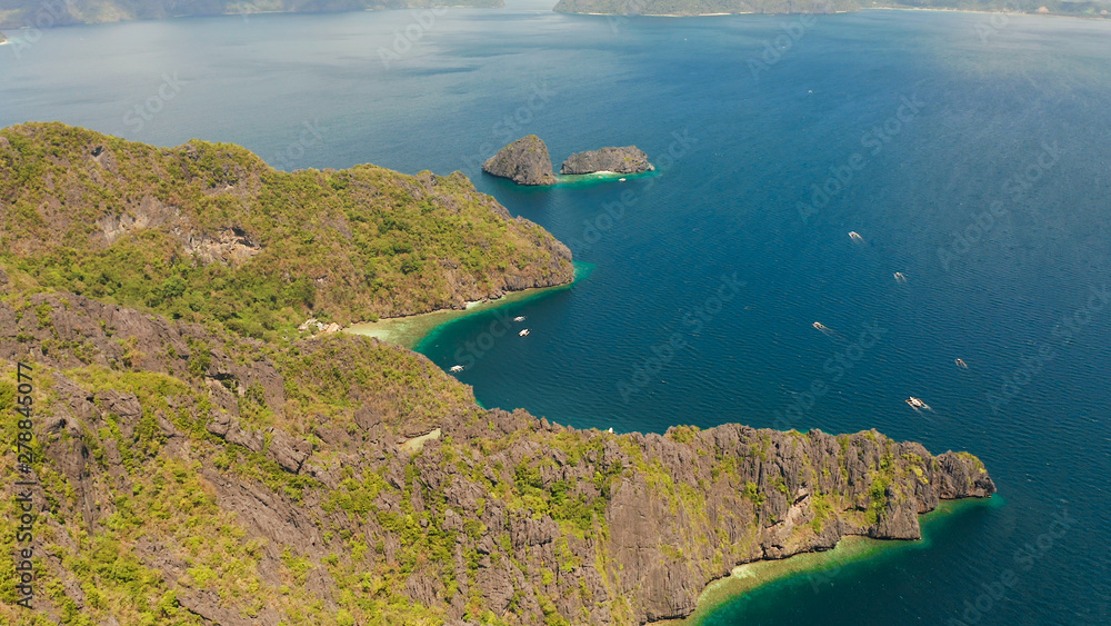 aerial view of bay and the tropical islands. Seascape with tropical rocky islands, ocean blue water. islands and mountains covered with tropical forest. El nido, Philippines, Palawan. Tropical