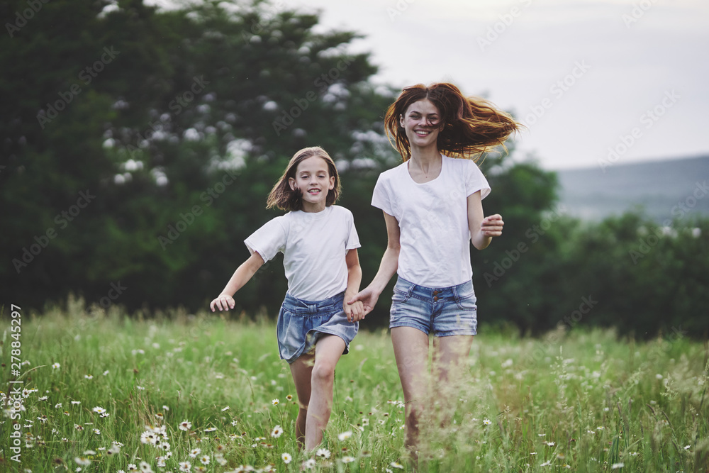 Obraz premium mother and daughter running in the field