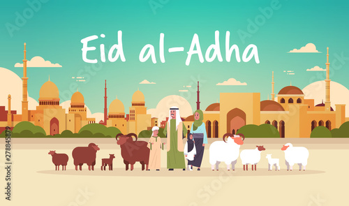 happy Eid al-Adha mubarak muslim holiday concept arab family standing with white and black flock of sheep festival of Sacrifice nabawi mosque building cityscape flat full length horizontal