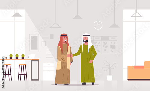 arabic businessmen handshaking arab business partners couple hand shake during meeting agreement partnership concept modern co-working center office interior full length horizontal