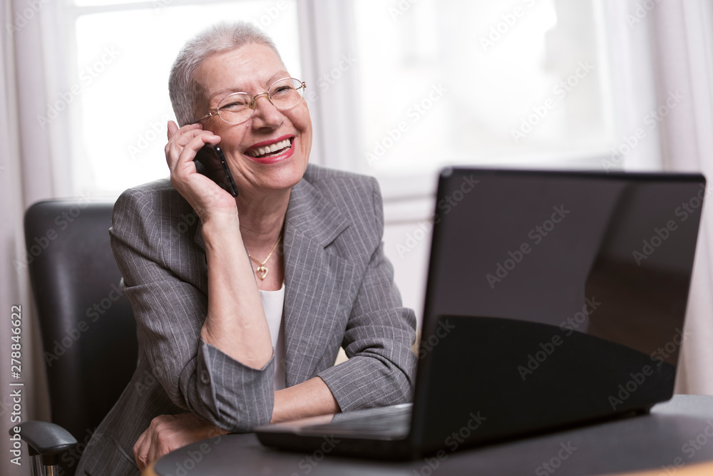 Older lady manager having a little break in her office Older lady manager having a little break in her office