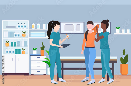 therapist examining injured patient african american nurse masseuse doing healing treatment manual sport physical therapy rehabilitation concept clinic office interior horizontal full length