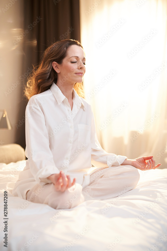 Woman sitting on bed Woman sitting on bed