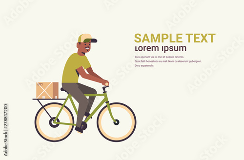postman in uniform riding bicycle carrying cardboard parcel box african american courier express delivery service concept flat full length horizontal copy space
