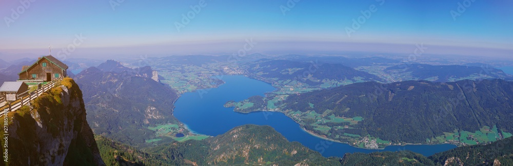 Aerial panoramic view of Austrian Alps nature, Mondsee lake from Schafberg peak near st. Wolfgang, Austria, Salzburg. Picturesque mountain lake in the summer morning landscape, large panorama banner.