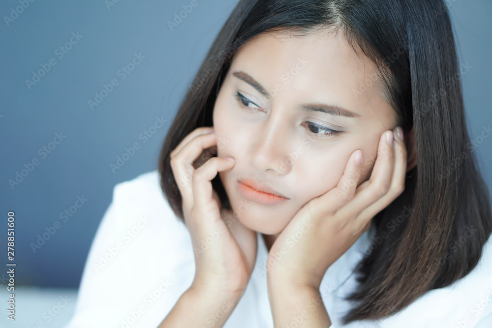 Closeup woman sitting on bed in the bedroom with thinking or depressed feeling, selective focus Closeup woman sitting on bed in the bedroom with thinking or depressed feeling, selective focus
