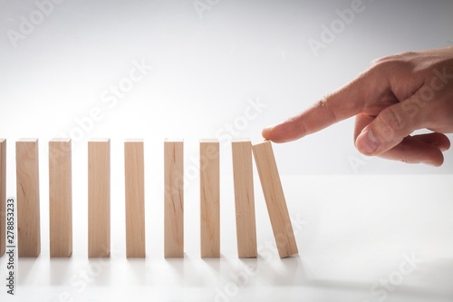 Hand Pushing Domino Pieces