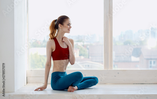 young woman doing fitness exercises in gym