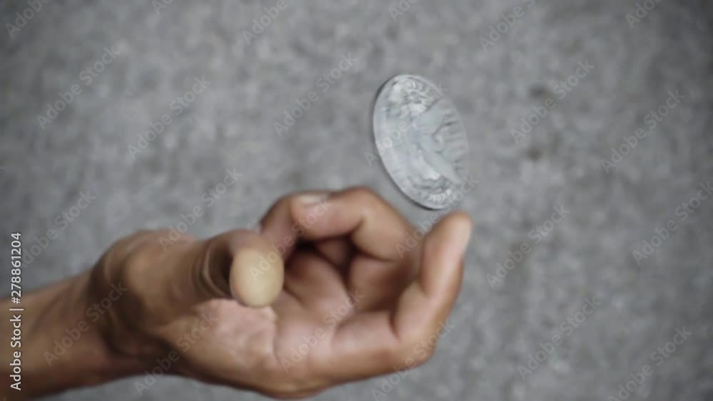slowmotion shot tossing coin to flip on heads or tails slowmotion shot tossing coin to flip on heads or tails