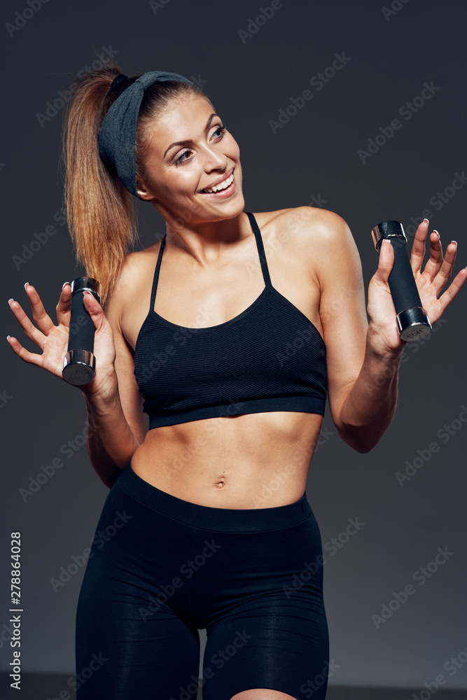 young woman exercising with dumbbells young woman exercising with dumbbells