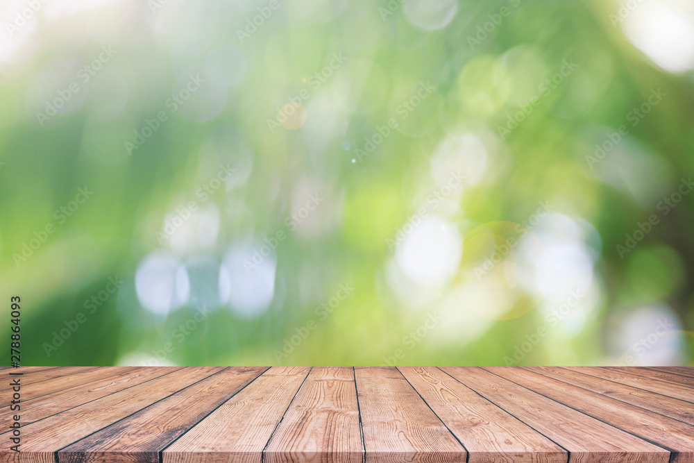 Abstract spring or summer with bokeh background and wooden tabletop Abstract spring or summer with bokeh background and wooden tabletop