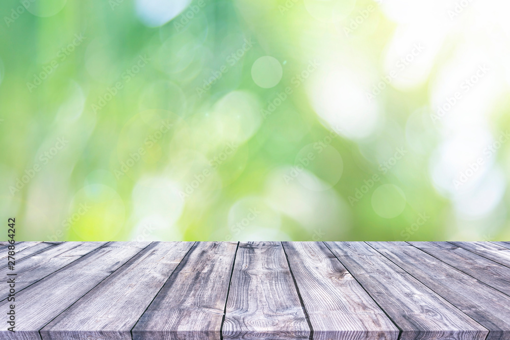 Abstract spring or summer with bokeh background and wooden tabletop Abstract spring or summer with bokeh background and wooden tabletop