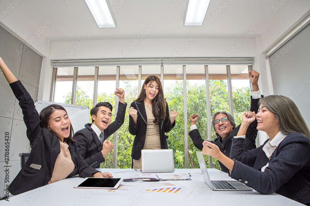 Team work of happy business people cheering in office. Celebrate success.  Business team celebrate a good job in the office. Asian people. Stock Photo  | Adobe Stock