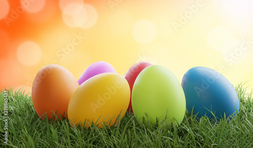 colored Easter eggs on grass 3d-illustration with bokeh orange background