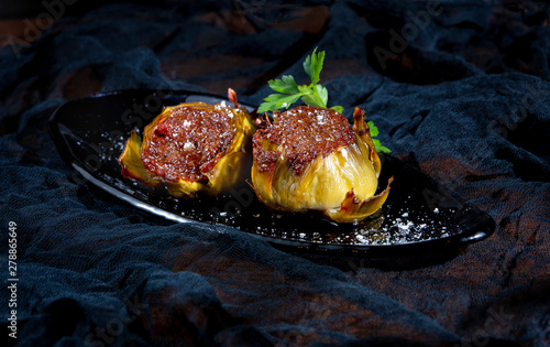 Close up of stuffed artichokes garnish with salt on plate photo