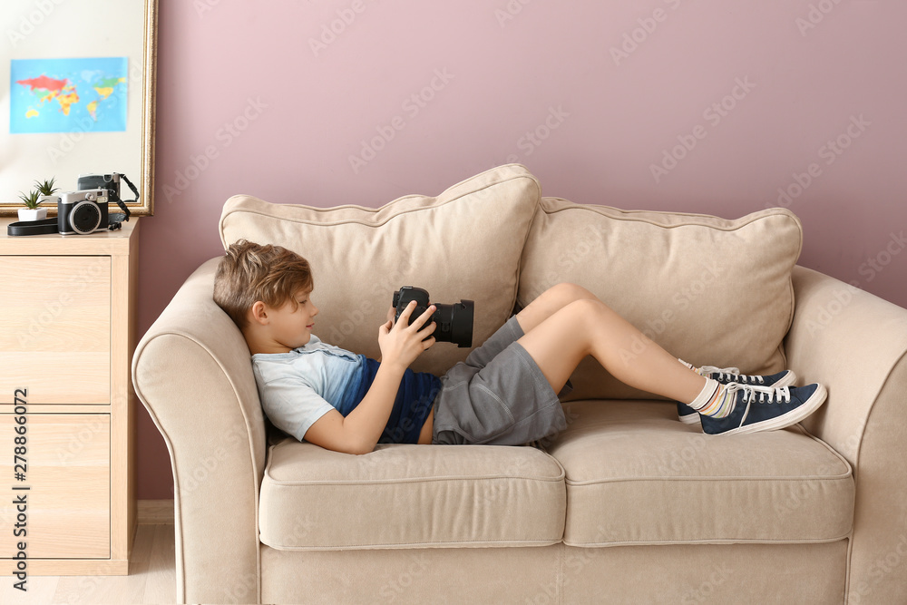 Cute little photographer with professional camera at home Cute little photographer with professional camera at home