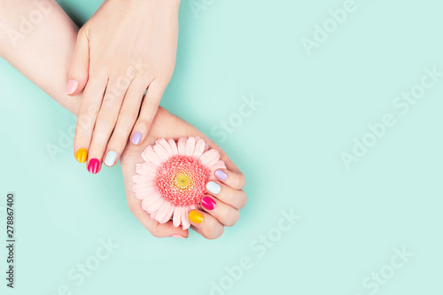 Woman hands with perfect manicure and flower.
