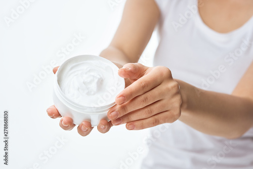 woman applying cream on her face