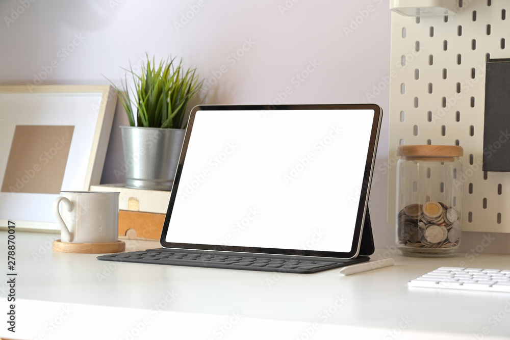 Mockup tablet with smart keyboard on minimal workspace table. Mockup tablet with smart keyboard on minimal workspace table.