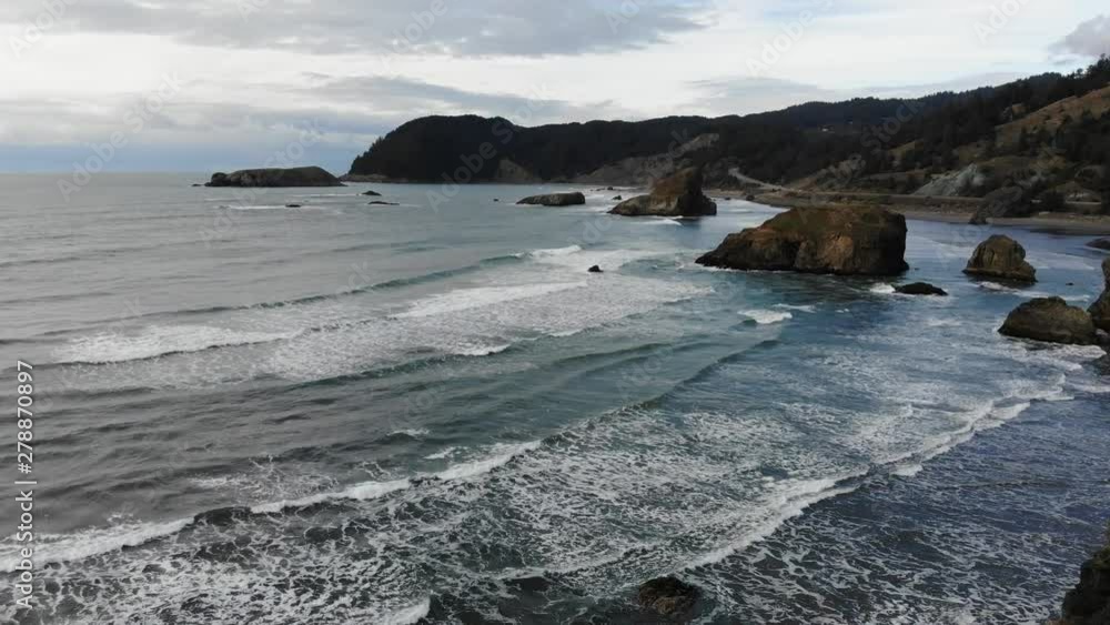 Drone flies over sea stacks and waves on the beach. Drone flies over sea stacks and waves on the beach.