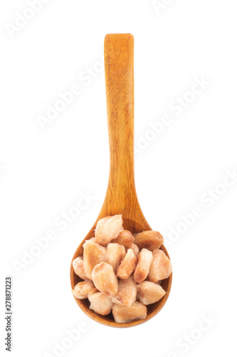 heap of cacao beans in wooden spoon isolated on white background. top view