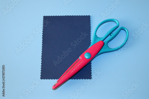 scrapbooking scissors, cloud pattern, rectangle cut out of colored paper