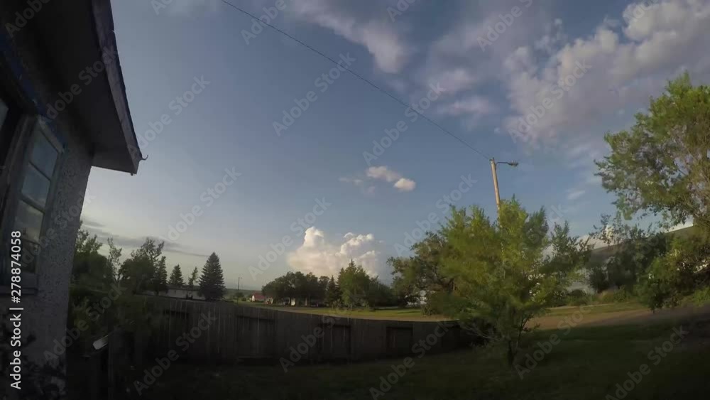 TIME LAPSE - Clouds in a blue sky skying over a small town in Alberta Canada. TIME LAPSE - Clouds in a blue sky skying over a small town in Alberta Canada.