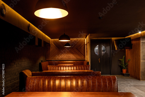 The interior of a nightclub, a pub in dark colors.