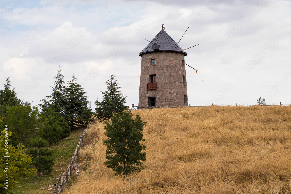 An Old Wooden Windmill in the Field