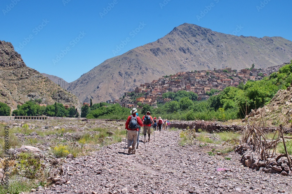 Hiking in High Atlas mountains in Morocco. Townscape of Imlil in the background