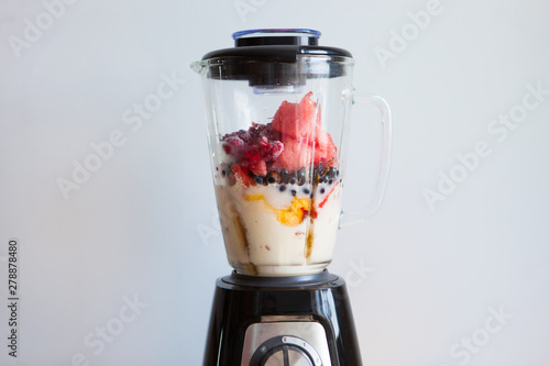 Obraz na plátně A blender filled with fresh whole fruits for making a smoothie or juice