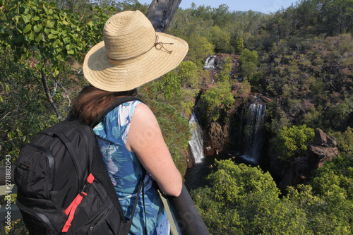 Woman tourist looking at lorence Falls in Litchfield National Park Northern Territory Australia