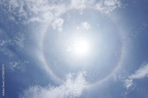 Bang Bua Thong, Nonthaburi Province, Thailand - 17 July 2019: beautiful sun halo phenomenon or sun with circular rainbow over the skys. photo