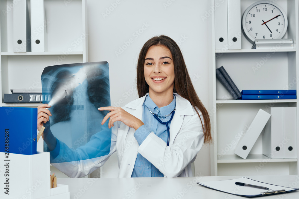 female doctor looking at xray female doctor looking at xray