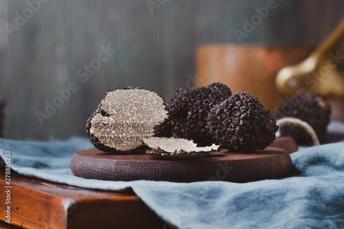 Φωτογραφία Black truffles  mushrooms on rustic wooden table with free text space