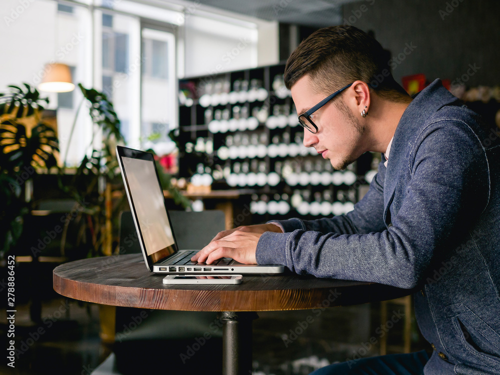 business man with laptop in cafe