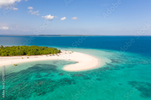 Patawan island. Small tropical island with white sandy beach. Beautiful island on the atoll  view from above. Nature of the Philippine Islands.