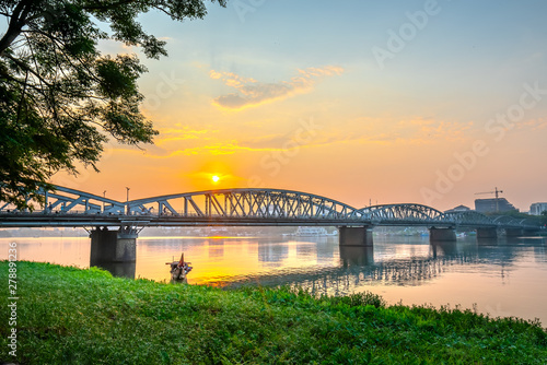 Dawn at Trang Tien Bridge. This is a Gothic architectural bridge spanning the Perfume river from the 18th century designed by Gustave Eiffel in Hue, Vietnam