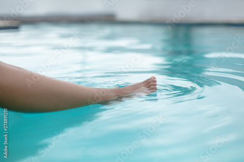 Womans feet in swimming pool
