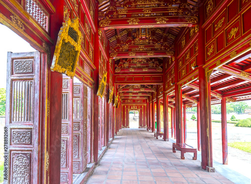 Amazing wooden hallway in the imperial Forbidden Citadel. The place that leads to the palaces of kings, feudal officials in the 19th century in Hue, Vietnam