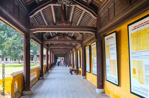 Tourists visit walk along wooden hallway corridors of the Thai Hoa Palace in the Imperial City in Hue, Vietnam.