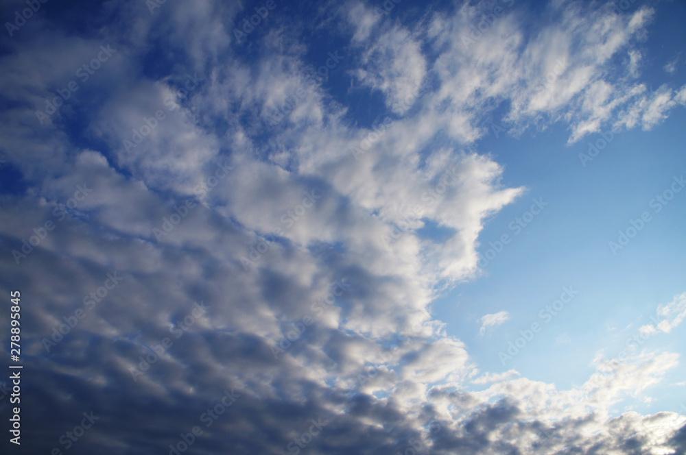 White and blue contrasting blue clouds in the sky. White and blue contrasting blue clouds in the sky.