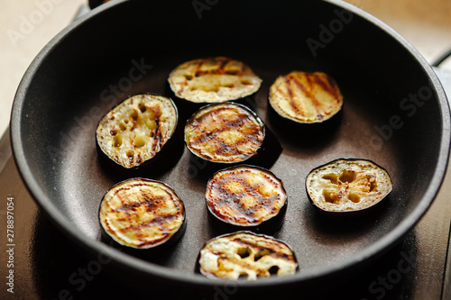 Eggplants are fried in a skillet. Close-up.